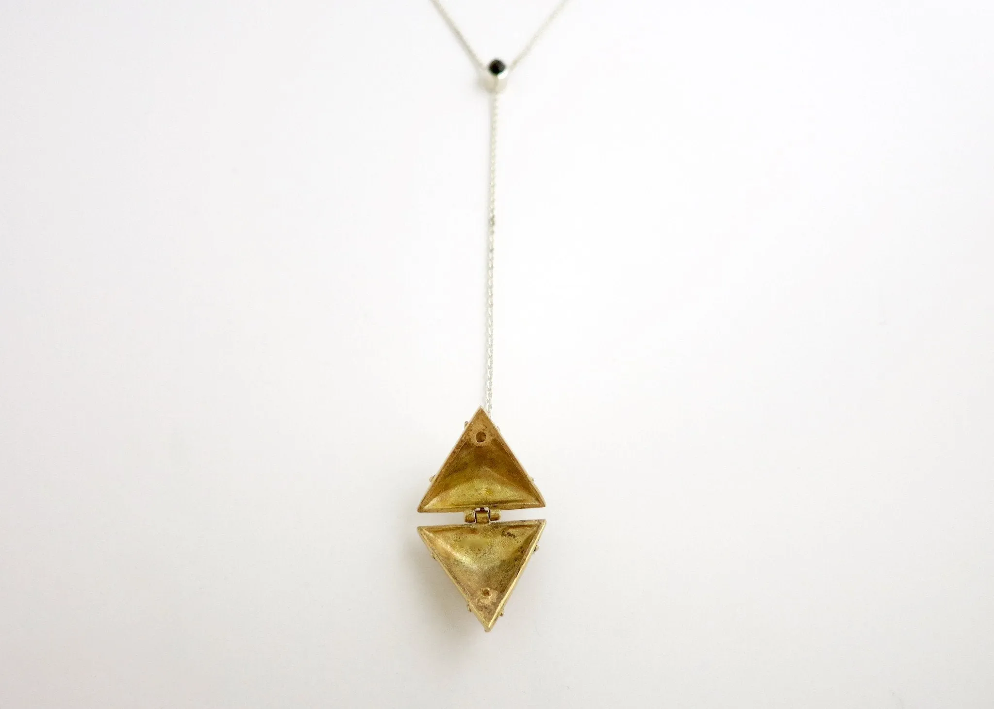 Dainty, long, bi-metal lariat necklace with gold plated brass triangular locket on sterling silver chain