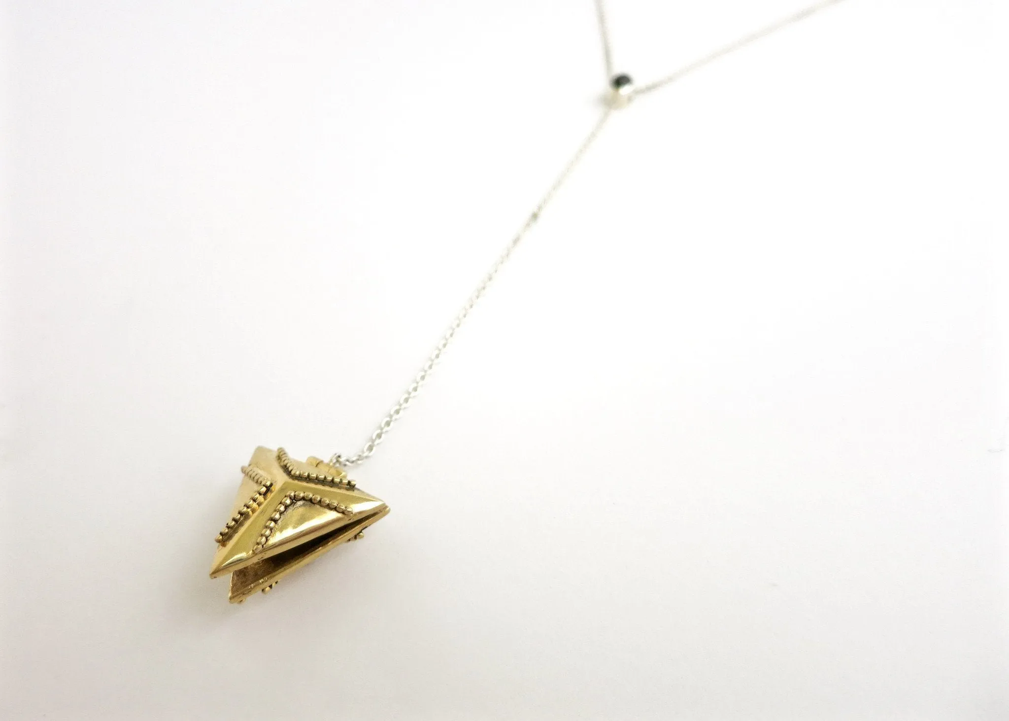 Dainty, long, bi-metal lariat necklace with gold plated brass triangular locket on sterling silver chain